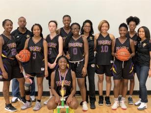 Columbia's girls basketball team with the third-place trophy at the B-Town Classic in South Carolina. (COURTESY)