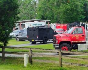 Law enforcement and fire rescue vehicles stage at Gibson Park on Wednesday morning during a standoff at a Hamilton County residence. (JASON WILKINSON/Lake City Reporter)