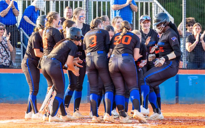 Teammates surround Mallory Blue after the Branford first baseman homered during Monday's District 6-1A quarterfinals against Lafayette. (JACK HOWDESHELL/Special to the Reporter)
