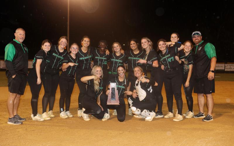The Suwannee Bulldogs pose with the District 2-3A championship trophy after defeating Florida High 4-1 on Thursday. (PAUL BUCHANAN/Special to the Reporter)