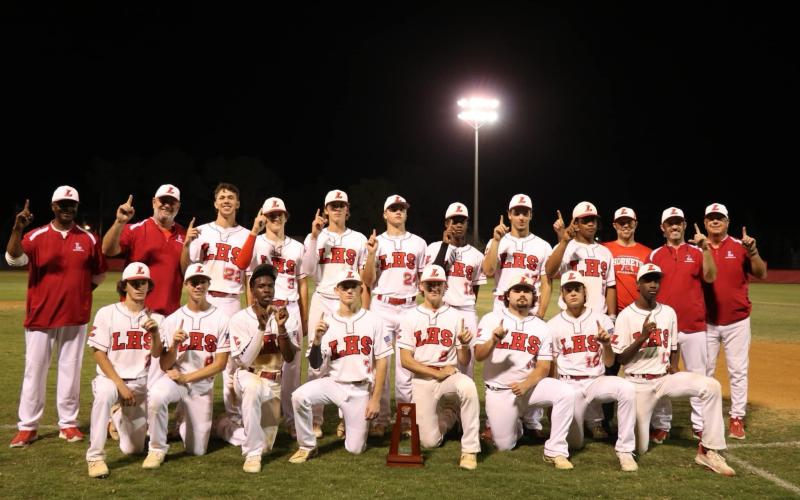 The Lafayette Hornets pose with the District 6-1A championship trophy after defeating Union County 2-1 on Thursday. (COURTESY)