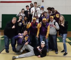 Columbia's wrestling team celebrates is pictured with the trophy after winning the District 2-2A IBT Tournament on Saturday. (COURTESY)
