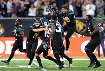 Jacksonville Jaguars kicker Matthew Wright (15) celebrates with teammates after kicking the game-winning field goal against the Miami Dolphins at Tottenham Hotspur Stadium on Oct. 17 in London, England. (ALEX PANTLING/Getty Images/TNS)
