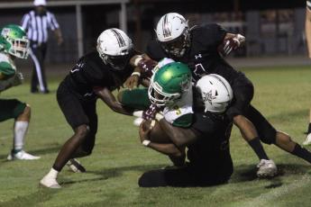 Suwannee running back Malachi Graham is tackled by a host of Madison County defenders on Friday. (PAUL BUCHANAN/Special to Reporter)