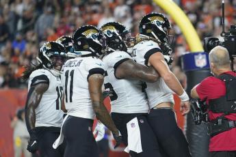 Jacksonville Jaguars quarterback Trevor Lawrence, front, celebrates with teammates after rushing for a touchdown against the Cincinnati Bengals on Sept. 30 in Cincinnati. (MICHAEL CONROY/Associated Press)