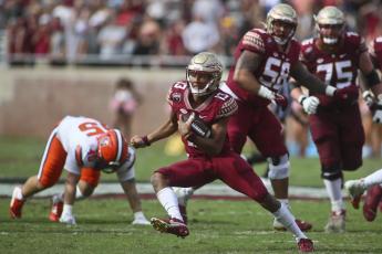Florida State quarterback Jordan Travis (13) makes a cut for a long run against Syracuse on Oct. 2 in Tallahassee, (PHIL SWARS/Associated Press)
