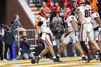 Georgia quarterback Stetson Bennett (13) celebrates with tight end Brock Bowers (19) after scoring a touchdown against Tennessee during Saturday's game in Knoxville, Tenn. (WADE PAYNE/Associated Press)