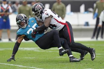 Jacksonville Jaguars running back James Robinson is stopped by Atlanta Falcons linebacker Foyesade Oluokun during Sunday’s game n Jacksonville. (CHRIS O’MEARA/Associated Press)