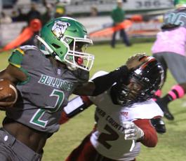 Suwannee receiver Jay Smith stiff arms a Baker County defender on Oct. 29. (PAUL BUCHANAN/Special to the Reporter)