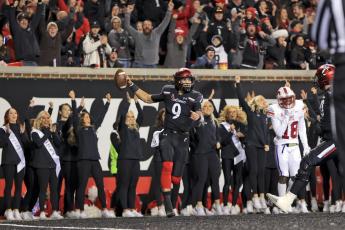 Cincinnati quarterback Desmond Ridder celebrates after catching a touchdown pass against SMU on Saturday in Cincinnati. Cincinnati won 48-14. (AARON DOSTER/Associated Press)