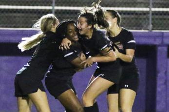 Columbia players celebrate with Olivia Kelly (middle left) after she scored a goal against Gainesville on Tuesday night. (MORGAN MCMULLEN/Lake City Reporter)