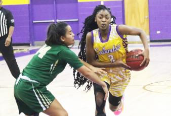 Columbia guard Na’Haviya Paxton drives to the basket as Nease guard Savannah Gomes defends on Tuesday night. (JORDAN KROEGER/Lake City Reporter)