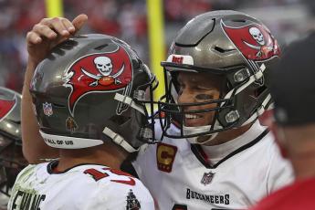 Tampa Bay Buccaneers quarterback Tom Brady, right, celebrates with wide receiver Mike Evans after Evans caught a touchdown pass against the Philadelphia Eagles during Sunday's wild-card playoff game in Tampa. (MARK LOMOGLIO/Associated Press)