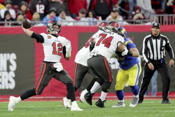 Tampa Bay Buccaneers quarterback Tom Brady (12) passes the ball as Tampa Bay Buccaneers guard Ali Marpet (74) blocks during an NFL divisional playoff game between the Los Angeles Rams and Tampa Bay Buccaneers on Jan. 23 in Tampa. (AP FILE)