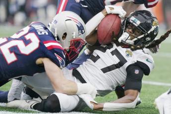 Jacksonville Jaguars cornerback Chris Claybrooks is taken down by New England Patriots defensive back Cody Davis during Sunday's game in Foxborough, Mass. (STEVEN SENNE/Associated Press)
