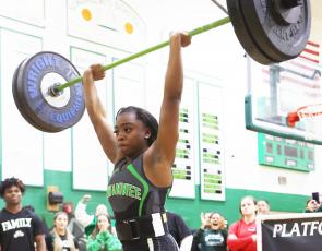 Suwannee lifter Tyra Kalandyk finishes her clean and jerk during the Region 1-1A Meet on Friday. (PAUL BUCHANAN/Special to the Reporter)