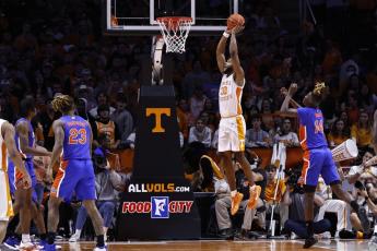 Tennessee guard Josiah-Jordan James (30) goes for a dunk past Florida guard Kowacie Reeves (14) during Wednesday's game in Knoxville, Tenn. Tennessee won 78-71. (WADE PAYNE/Associated Press)