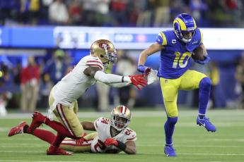 Los Angeles Rams receiver Cooper Kupp (10) gets past San Francisco 49ers safety Jaquiski Tartt, left, and cornerback K'Waun Williams (24) during the NFC Championship game on Sunday in Inglewood, Calif. (JED JACOBSOHN/Associated Press)