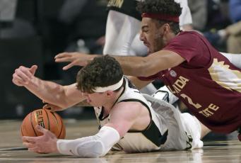 Wake Forest's Jake LaRavia, bottom, and Florida State's Anthony Polite battle for a loose ball during Tuesday's game at Joel Coliseum in Winston-Salem, N.C. (WALT UNKS/The Winston-Salem Journal via AP)