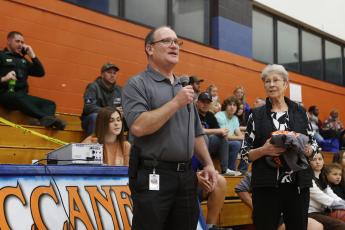 Suwannee County Superintendent Ted Roush (left) offers a few words in honor of forme Branford coach and teacher LeNelle Morgan before the Branford gym is dedicated to her. (PAUL BUCHANON/Special to the Reporter)