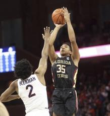 Florida State guard Matthew Cleveland (35) shoots over Virginia guard Reece Beekman (2) during Saturday’s game in Charlottesville, Va. (ANDREW SHURTLEFF/Associated Press)