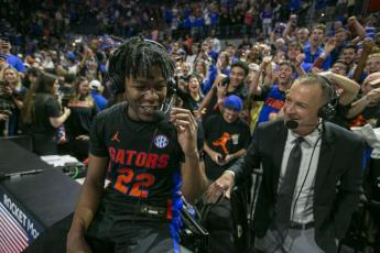 Florida guard Tyree Appleby (left) talks with broadcasters as he celebrates Florida's 63-62 win over Auburn on Saturday  in Gainesville. (ALAN YOUNGBLOOD/Associated Press)