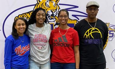 Columbia guard Na’Haviya Paxton (center left) signed her letter of intent to play at Florida Southern on Saturday. She is pictured with Columbia assistant coach Erica Mayo (left), Columbia assistant coach Keisha Kimble (center right) and Columbia head coach Anthony Perry. (COURTESY)