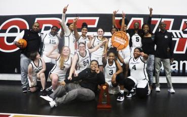 Fort White's girls basketball team celebrates after defeating Bradford for the District 6-1A championship on Friday. (MORGAN MCMULLEN/Lake City Reporter)