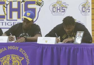 Columbia defensive end Adeon Farmer and running back Jaelin Brown sign their letters of intent Wednesday morning to play at Fort Valley State. (JAMIE WACHTER/Lake City Reporter)
