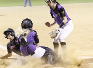 Branford outfielder Ellie Frierson slides into home plate safely to score a run before Columbia catcher Haley Cook can apply a tag on Tuesday night. (JORDAN KROEGER/Lake City Reporter)