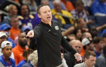 Florida head coach Mike White directs his players during a game against Texas A&M at the Southeastern Conference tournament on March 10 in Tampa. (CHRIS O’MEARA/Associated Press)