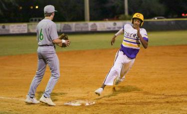 Columbia first baseman Brayden Thomas turns off third base and heads home to score a run against Suwannee on Tuesday night. (BRENT KUYKENDALL/Lake City Reporter)