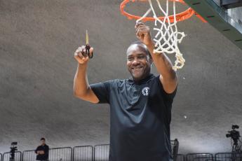 FGC head coach Charles Ruise cuts down a piece of the net after the Timberwolves defeated Pasco-Hernando State College to win the Region 8 championship on Saturday at the Howard Center. (COURTESY)
