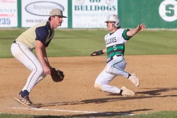 Suwannee’s Josh Fernald slides into third base ahead of a throw against Holmes County on Monday. (PAUL BUCHANAN/Special to the Reporter)