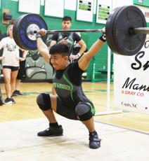 Suwannee’s Yael Hernandez performs the clean and jerk during the Bulldog Invitational on Friday. (PAUL BUCHANAN/Special to the Reporter)