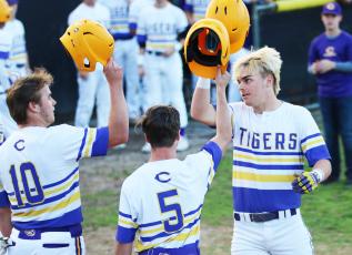 Columbia third baseman Hayden Gustavson (right) celebrates at home plate with first baseman Brent Howard (10) and outfielder Matthew Dumas (5) after hitting a 3-run home run against Valwood in the first inning Monday night. (JORDAN KROEGER/Lake City Reporter)
