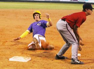 Columbia third baseman Hayden Gustavson slides into third base safely against Baker County on Tuesday night. (MORGAN MCMULLEN/Lake City Reporter)