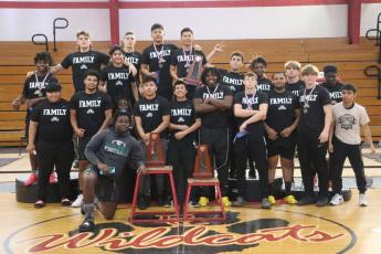 Suwannee's boys weightlifting team poses with the District 3-2A trophies after winning titles in the traditional and snatch on Thursday. (MORGAN MCMULLEN/Lake City Reporter)