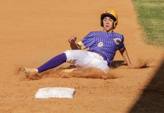 Columbia's Grant Bowers slides safely into third base during Monday's game against Bishop Kenny (BRENT KUYKENDALL/Lake City Reporter)