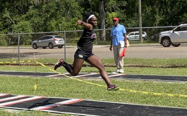 Columbia’s Stacy White won the District 3-3A title in the triple jump on Saturday. (DYLAN ASPENWALL/Special to the Reporter)