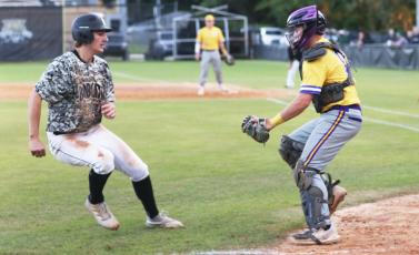 Columbia catcher Brent Howard tags out Buchholz runner JJ Gardner as he tries to score on Tuesday. (MORGAN MCMULLEN/Lake City Reporter)