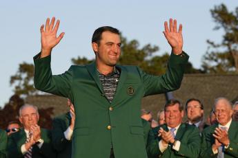 Scottie Scheffler celebrates after putting on the green jacket after winning the 86th Masters on Sunday in Augusta, Ga. (DAVID J. PHILLIP/Associated Press)