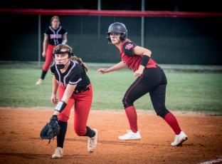 Fort White first baseman Hannah Brown tries to hold a Dixie County runner at first base during the Indians’ 2-1 loss Thursday night. (CHRISTINA FEAGIN/Special to the Reporter)