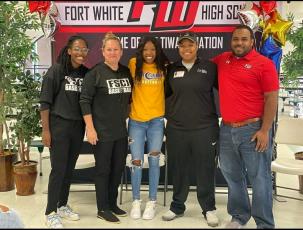 Fort White guard Jacovya Major (middle) signed her letter of intent to play at Florida State College at Jacksonville on Tuesday. Major is pictured with FSCJ assistant coach Jessica Eaton (left), FSCJ head coach Diane Couch (middle left), Fort White assistant coach Bregay Harris (middle right) and Fort White head coach DeShay Harris (right). (COURTESY)