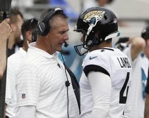 Jacksonville Jaguars head coach Urban Meyer (left) talks with place kicker Josh Lambo after Lambo missed his second field goal against the Denver Broncos on Sept. 19, 2021, in Jacksonville. (AP FILE)
