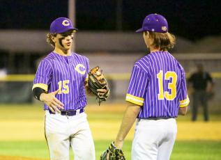 Columbia pitcher Truitt Todd (left) shakes hands with pitcher Philip Maddox as he exits the game in the seventh inning of Tuesday’s Region 1-5A quarterfinal against St. Augustine. (BRENT KUYKENDALL/Lake City Reporter)