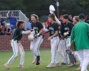 Suwannee’s Tyson Greene is congratulated by his teammates after hitting a two-run home run against Baker County in the fourth inning Wednesday in the Region 1-4A quarterfinals at Booster Field. (BRENT KUYKENDALL/Lake City Reporter)