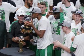 Boston Celtics center Al Horford kisses the NBA Eastern Conference trophy after defeating the Miami Heat in Game 7 of the Eastern Conference finals on Sunday in Miami. (WILFREDO LEE/Associated Press)