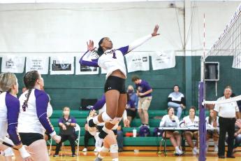 Former Columbia volleyball player Brandi Oliver rises up to hit against Fort White last season on Senior Night. (FILE)