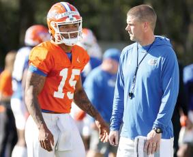 Florida quarterback Anthony Richardson, talking with Gators coach Billy Napier during a spring practice, has caught UF legend Steve Spurrier’s attention. (STEPHEN M. DOWELL/Orlando Sentinel/TNS)